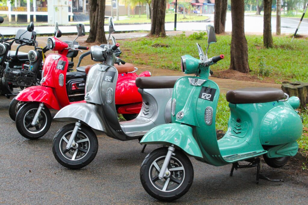 red electric scooter Vespa motor that uses battery power as propulsion